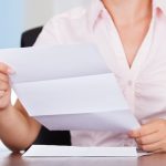 Closeup Of Young Businesswoman Holding Envelope With Letter