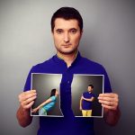 serious young man tearing the photo of couple